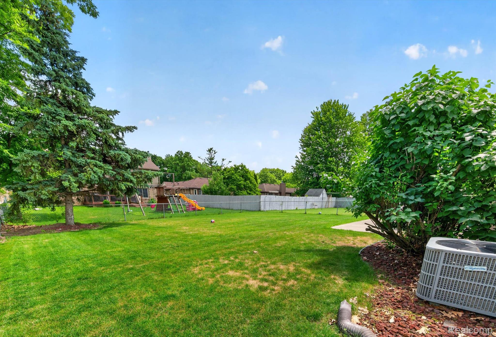 46362 Springhill Drive Utica, MI 48317 - Photo 41 of 59 Expansive lawn area featuring a large evergreen tree and mature perimeter plantings