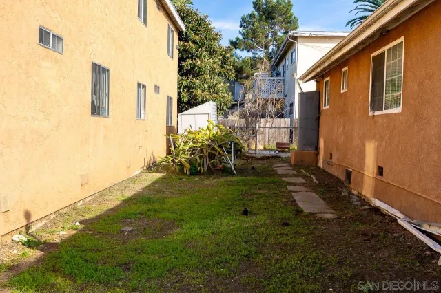 a view of a chairs and table in the backyard
