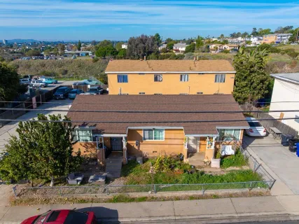 an aerial view of a house with a yard