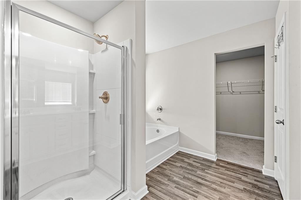 616 Hydrangea Lane Bremen, GA 30110 - Photo 13 of 49 a bathroom with a glass shower door and a bathtub