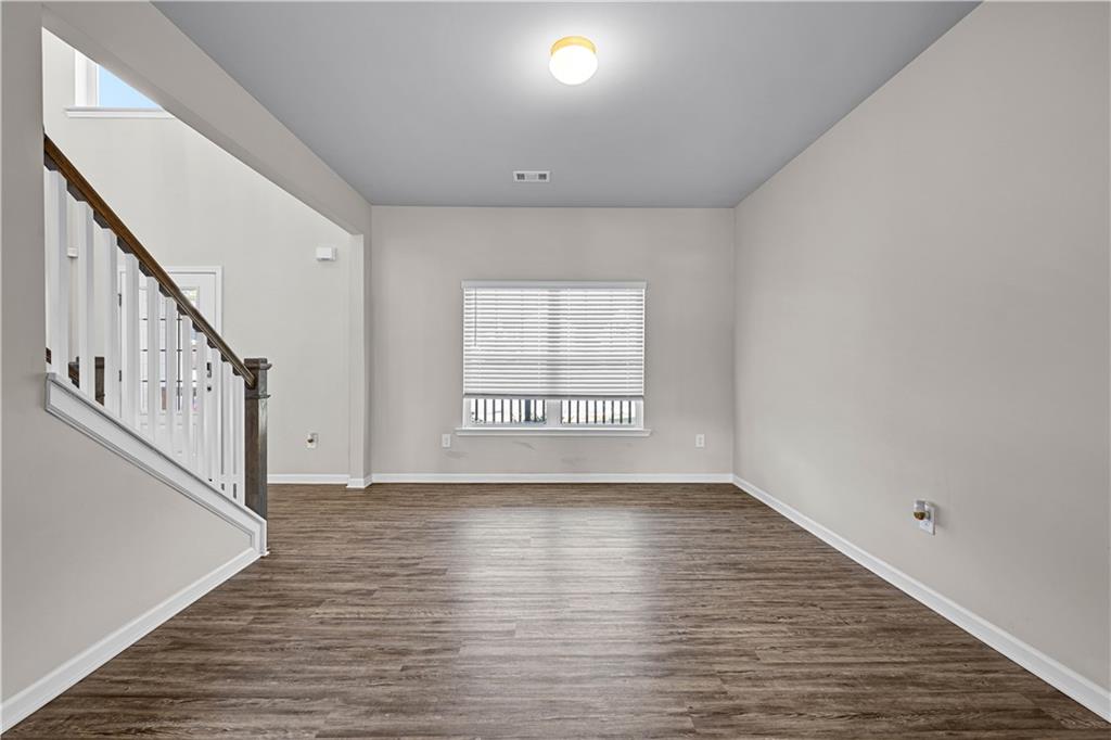 616 Hydrangea Lane Bremen, GA 30110 - Photo 16 of 49 a view of an empty room with wooden floor and a window