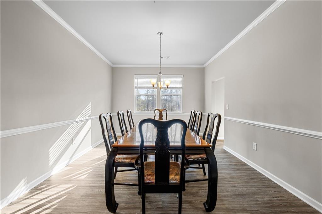 616 Hydrangea Lane Bremen, GA 30110 - Photo 19 of 49 a dining room with furniture a chandelier and wooden floor