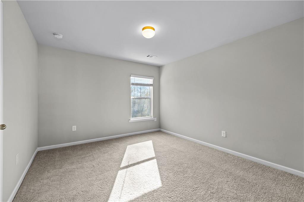 616 Hydrangea Lane Bremen, GA 30110 - Photo 28 of 49 an empty room with windows and chandelier fan