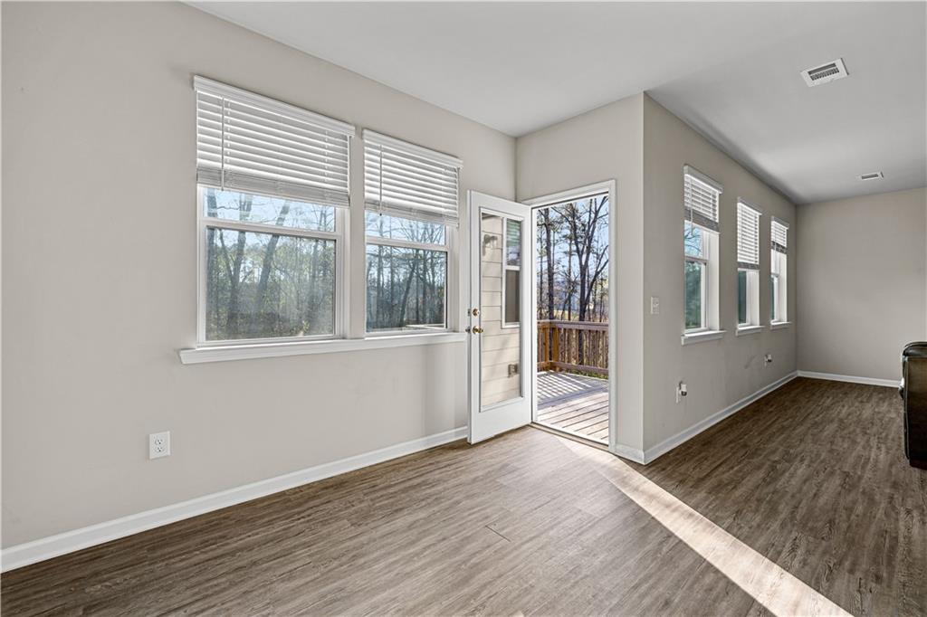 616 Hydrangea Lane Bremen, GA 30110 - Photo 31 of 49 a view of an empty room with wooden floor and a window