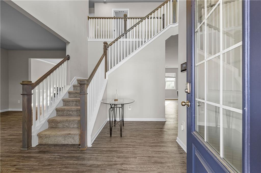 616 Hydrangea Lane Bremen, GA 30110 - Photo 36 of 49 a view of staircase with wooden floor and a floor to ceiling window