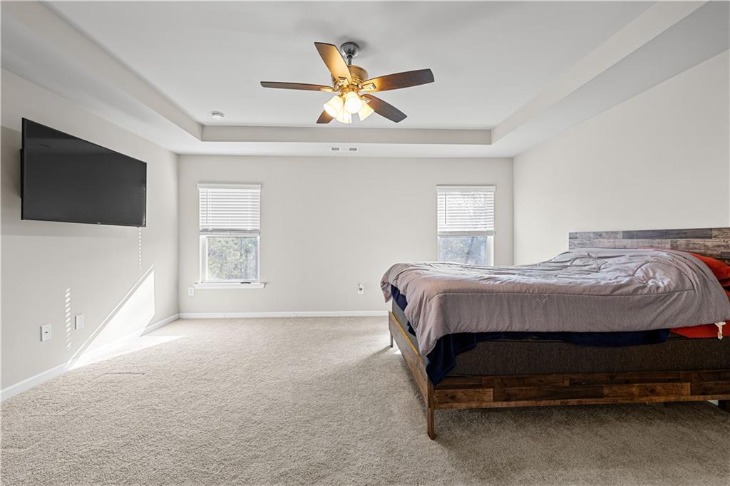 616 Hydrangea Lane Bremen, GA 30110 - Photo 8 of 49 a bedroom with a bed and a ceiling fan