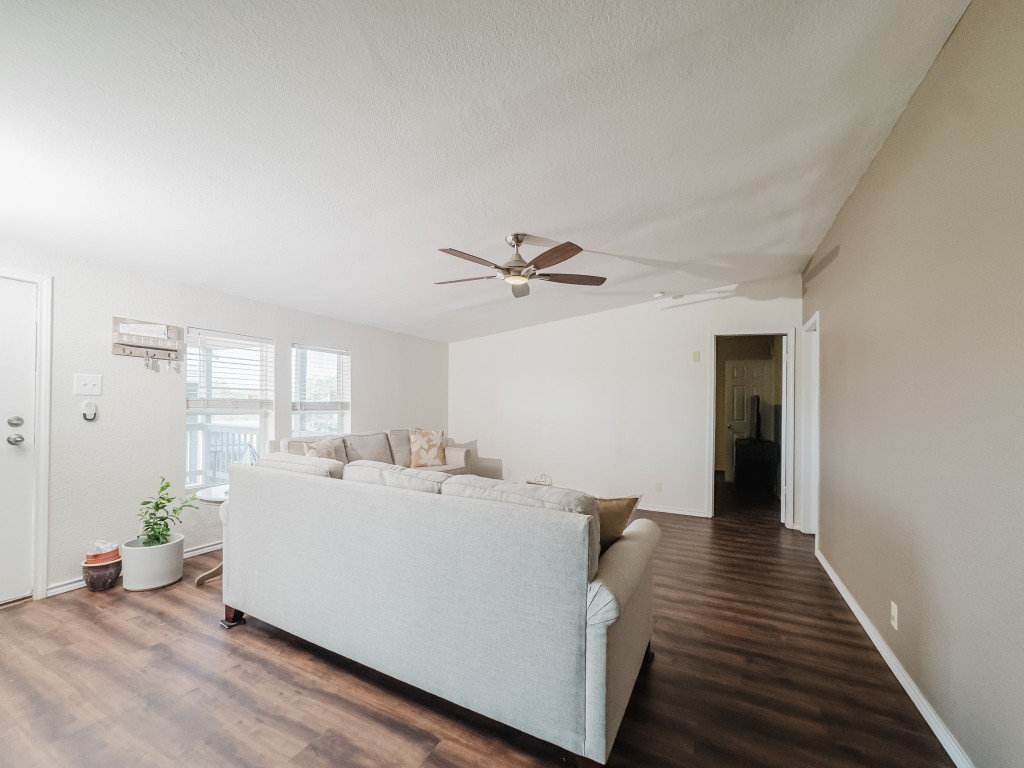 2709 County Road 463 Elgin, TX 78621 - Photo 13 of 40 Living area featuring vaulted ceiling, dark wood-type flooring, ceiling fan, and a textured ceiling