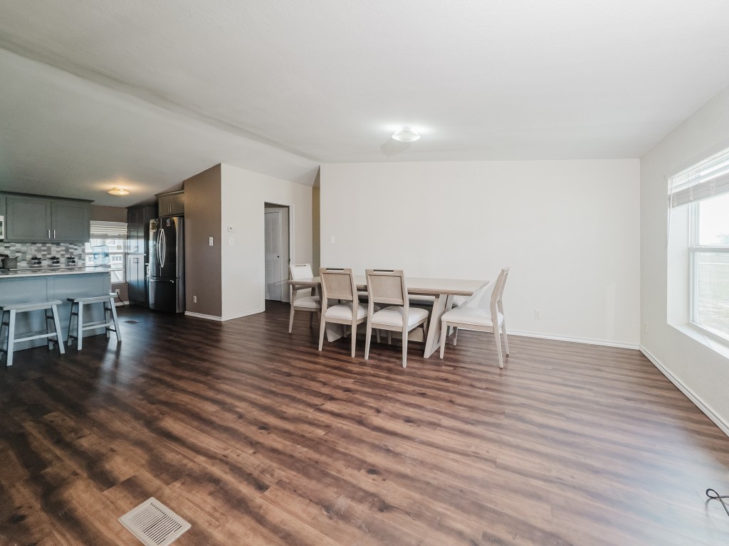 2709 County Road 463 Elgin, TX 78621 - Photo 15 of 40 Dining area with dark wood-style flooring and baseboards