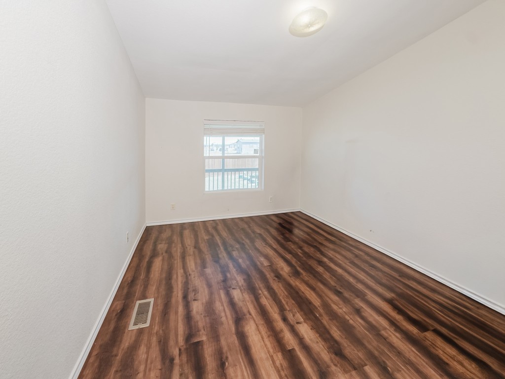 2709 County Road 463 Elgin, TX 78621 - Photo 21 of 40 Spare room with baseboards and dark wood finished floors