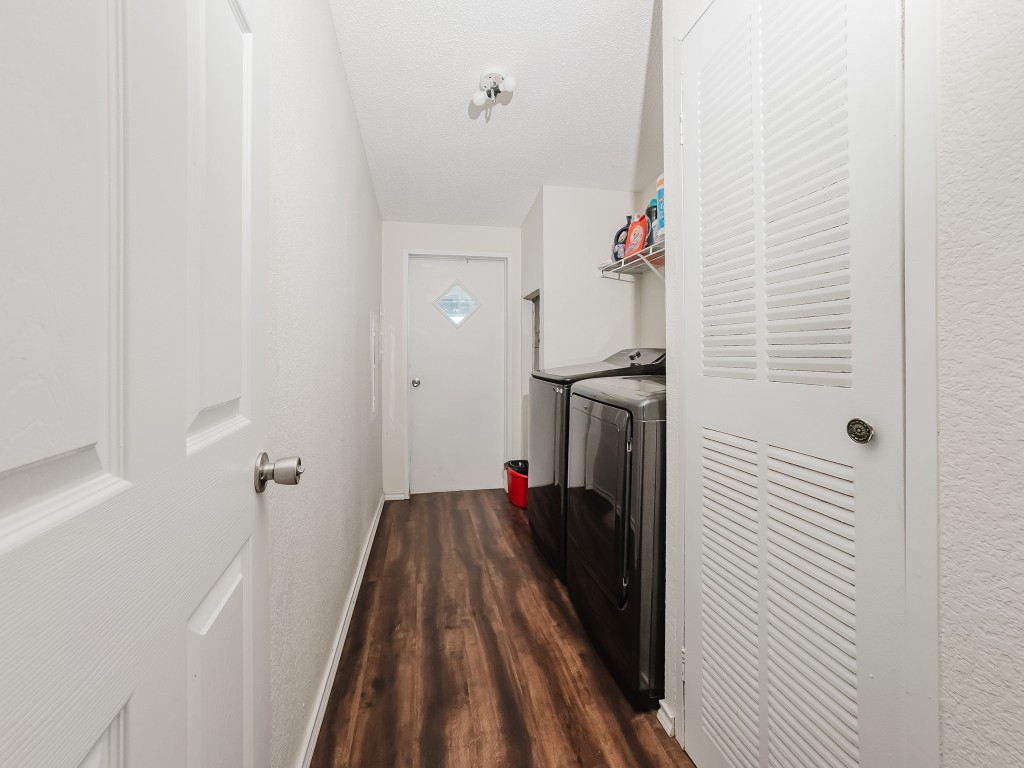 2709 County Road 463 Elgin, TX 78621 - Photo 28 of 40 Washroom with dark wood-style floors and separate washer and dryer