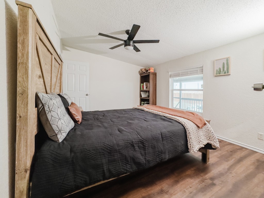 2709 County Road 463 Elgin, TX 78621 - Photo 31 of 40 Bedroom featuring a textured ceiling, ceiling fan, and wood finished floors