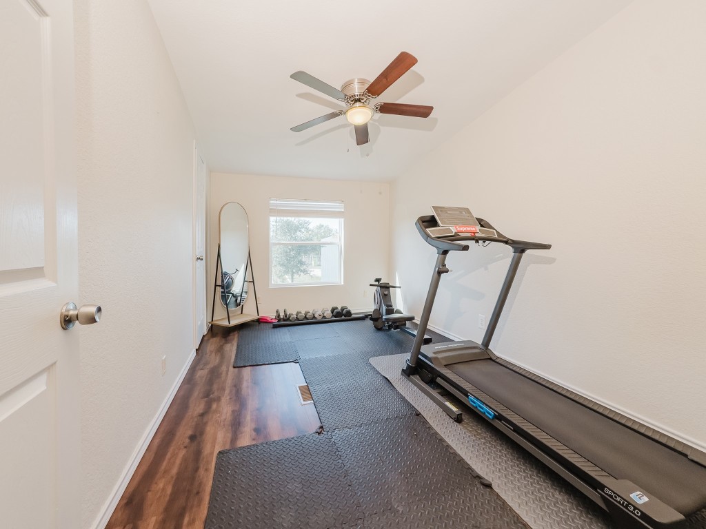 2709 County Road 463 Elgin, TX 78621 - Photo 34 of 40 Exercise room featuring dark wood-style flooring and a ceiling fan
