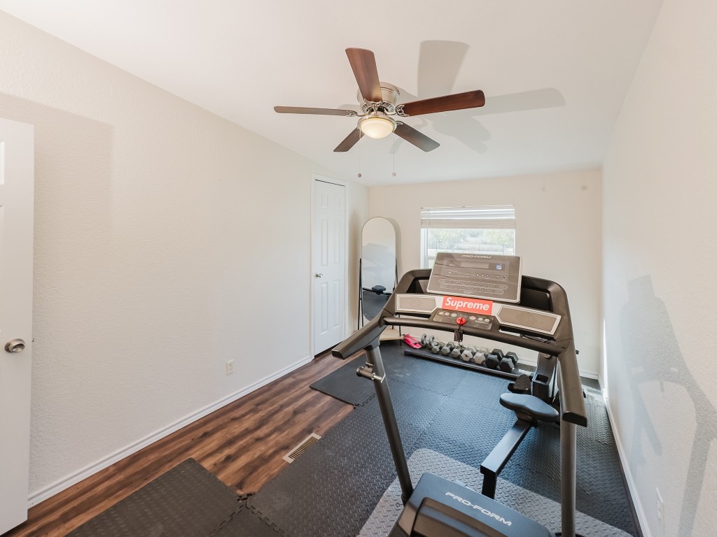 2709 County Road 463 Elgin, TX 78621 - Photo 35 of 40 Workout area featuring ceiling fan and wood finished floors