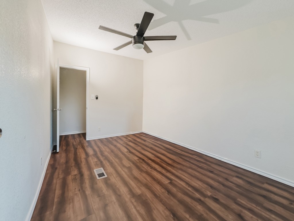 2709 County Road 463 Elgin, TX 78621 - Photo 37 of 40 Spare room with dark wood-style flooring, a ceiling fan, and a textured ceiling