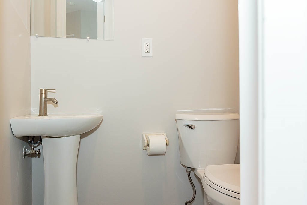 171 Walnut Street, Unit 4 Boston, MA 02122 - Photo 13 of 31 a bathroom with a sink a toilet and mirror