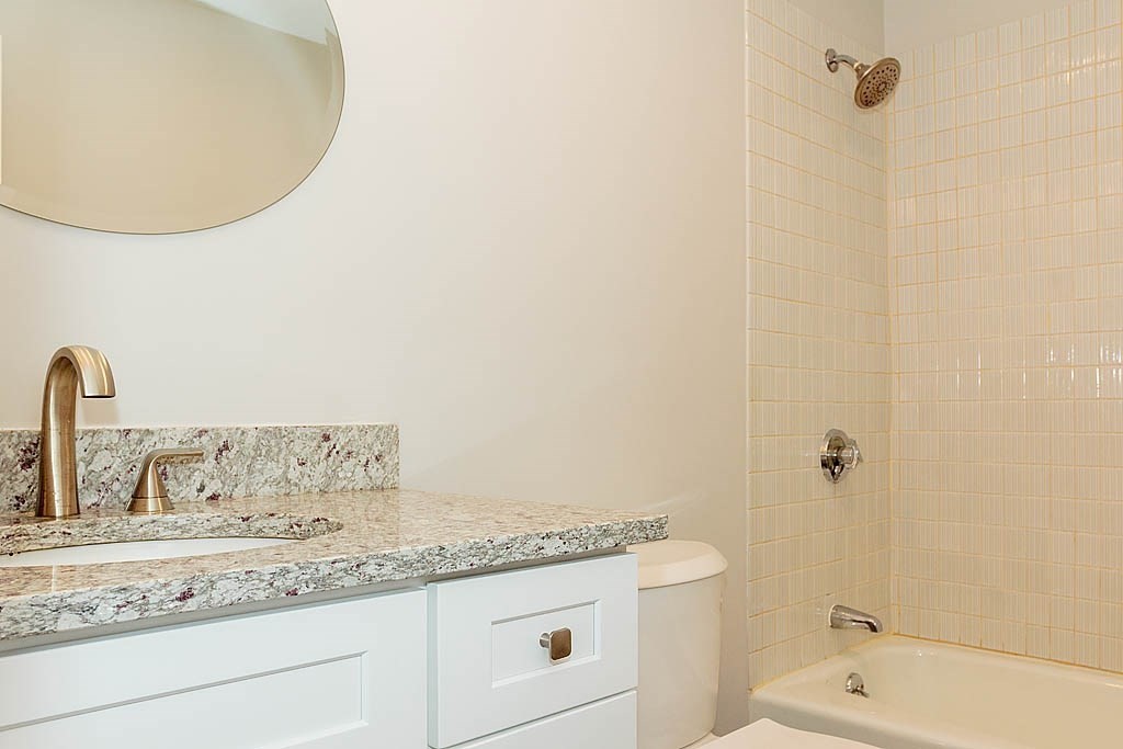 171 Walnut Street, Unit 4 Boston, MA 02122 - Photo 20 of 31 a bathroom with a granite countertop sink a toilet and shower
