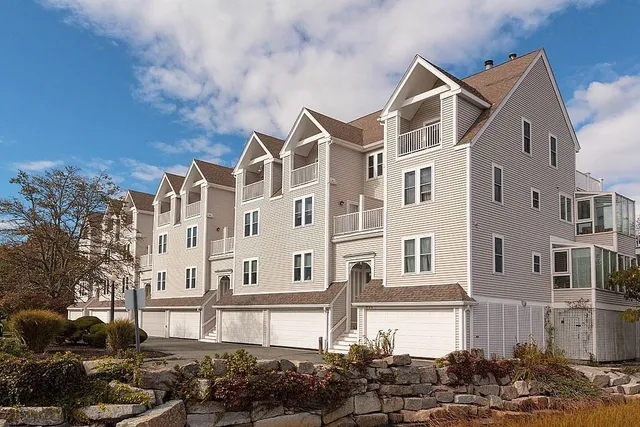 a front view of a residential apartment building with a yard