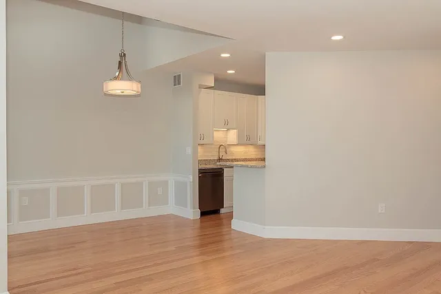 a view of a kitchen with a sink and wooden floor