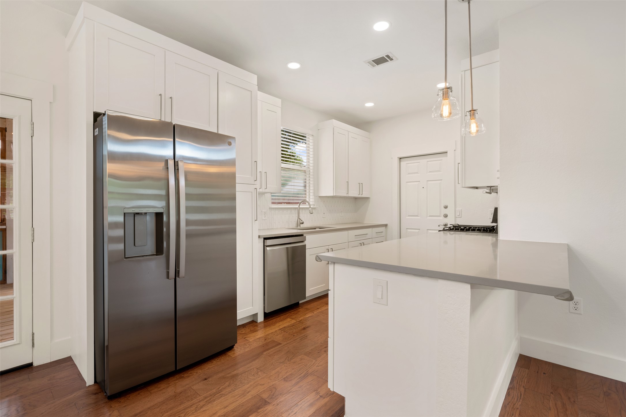 4912 Sara Drive, Unit A Austin, TX 78721 - Photo 10 of 28 Kitchen with stainless steel appliances, breakfast bar, and ample cabinet space. NEW refrigerator.