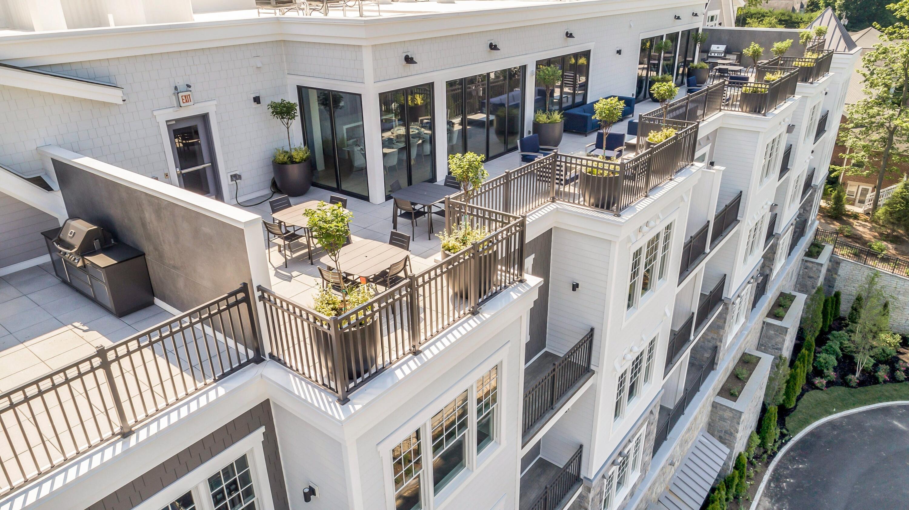 180 Park Street, Unit 204 New Canaan, CT 06840 - Photo 20 of 31 a view of a patio with couches table and chairs and potted plants