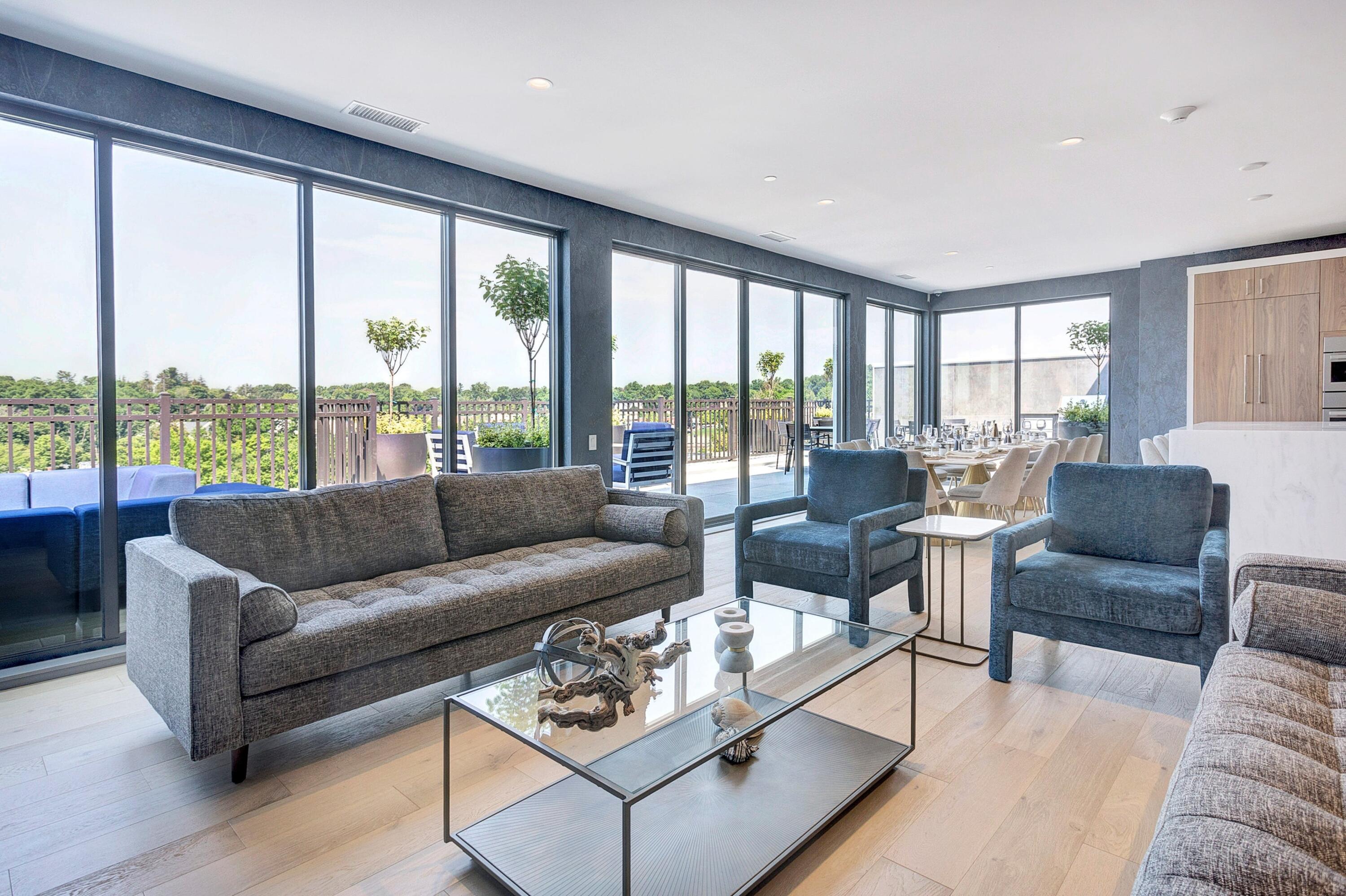 180 Park Street, Unit 204 New Canaan, CT 06840 - Photo 21 of 31 a living room with furniture and floor to ceiling windows