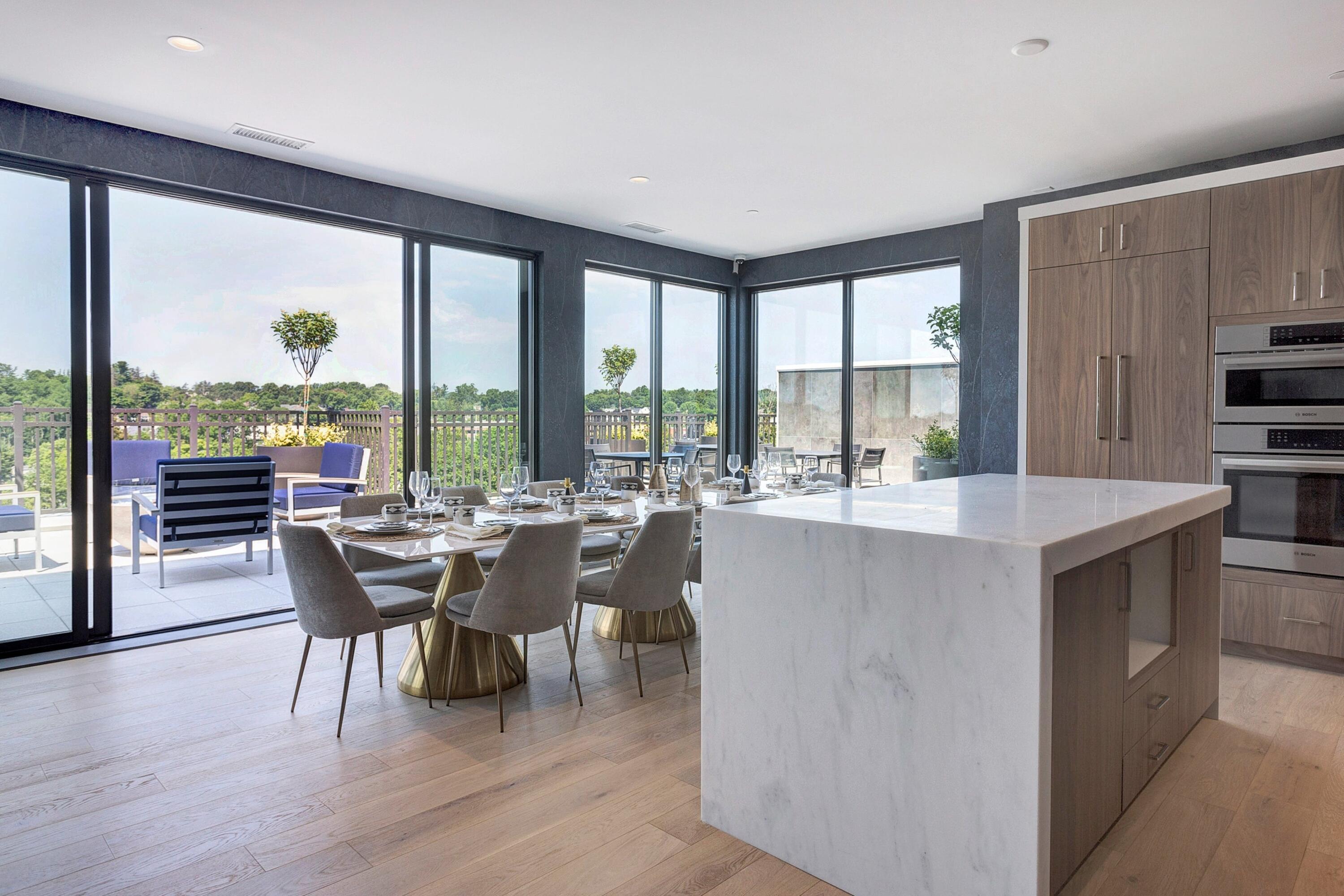 180 Park Street, Unit 204 New Canaan, CT 06840 - Photo 23 of 31 a dining room with furniture a large window and a kitchen view