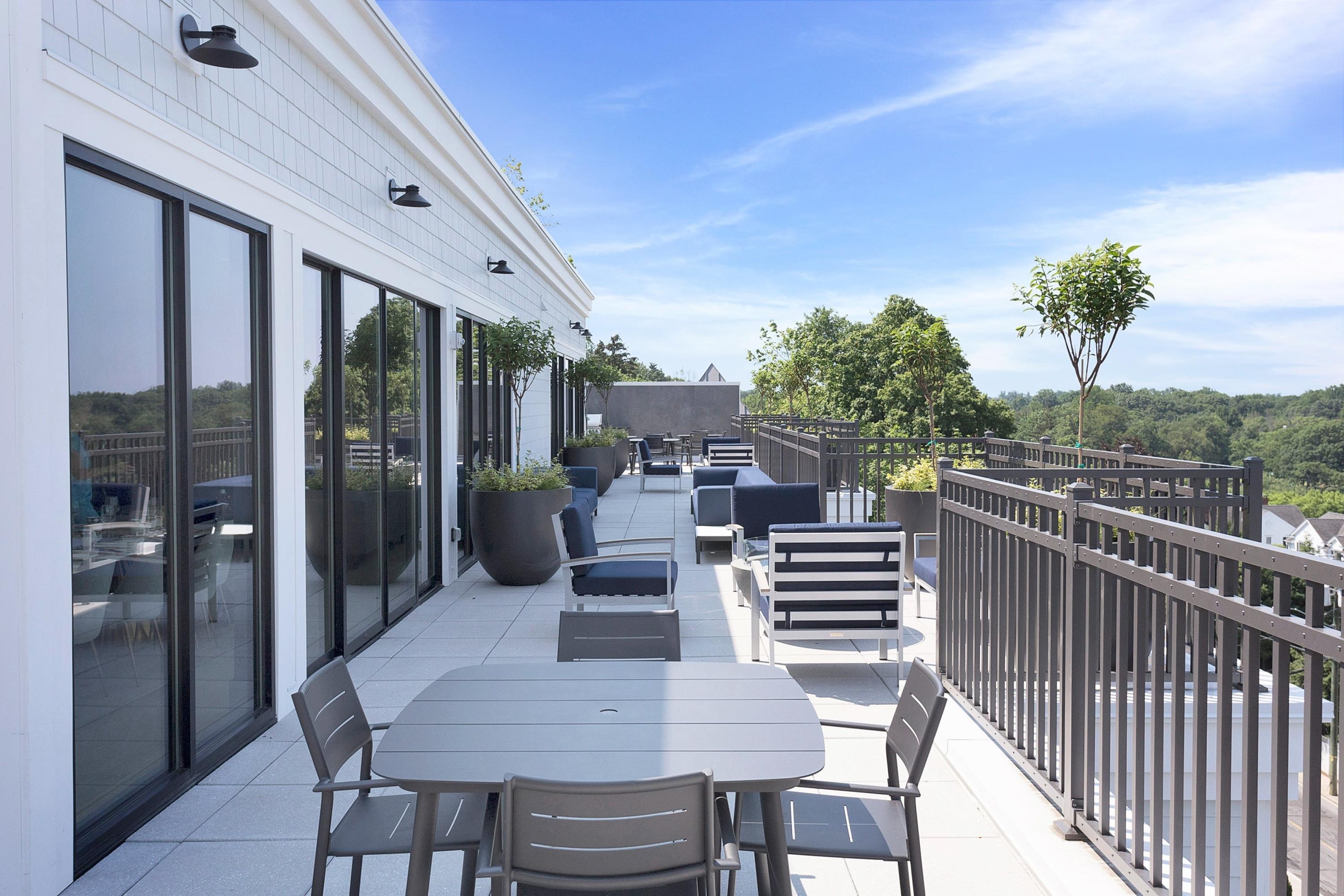 180 Park Street, Unit 204 New Canaan, CT 06840 - Photo 27 of 31 a view of a chairs and table in the balcony