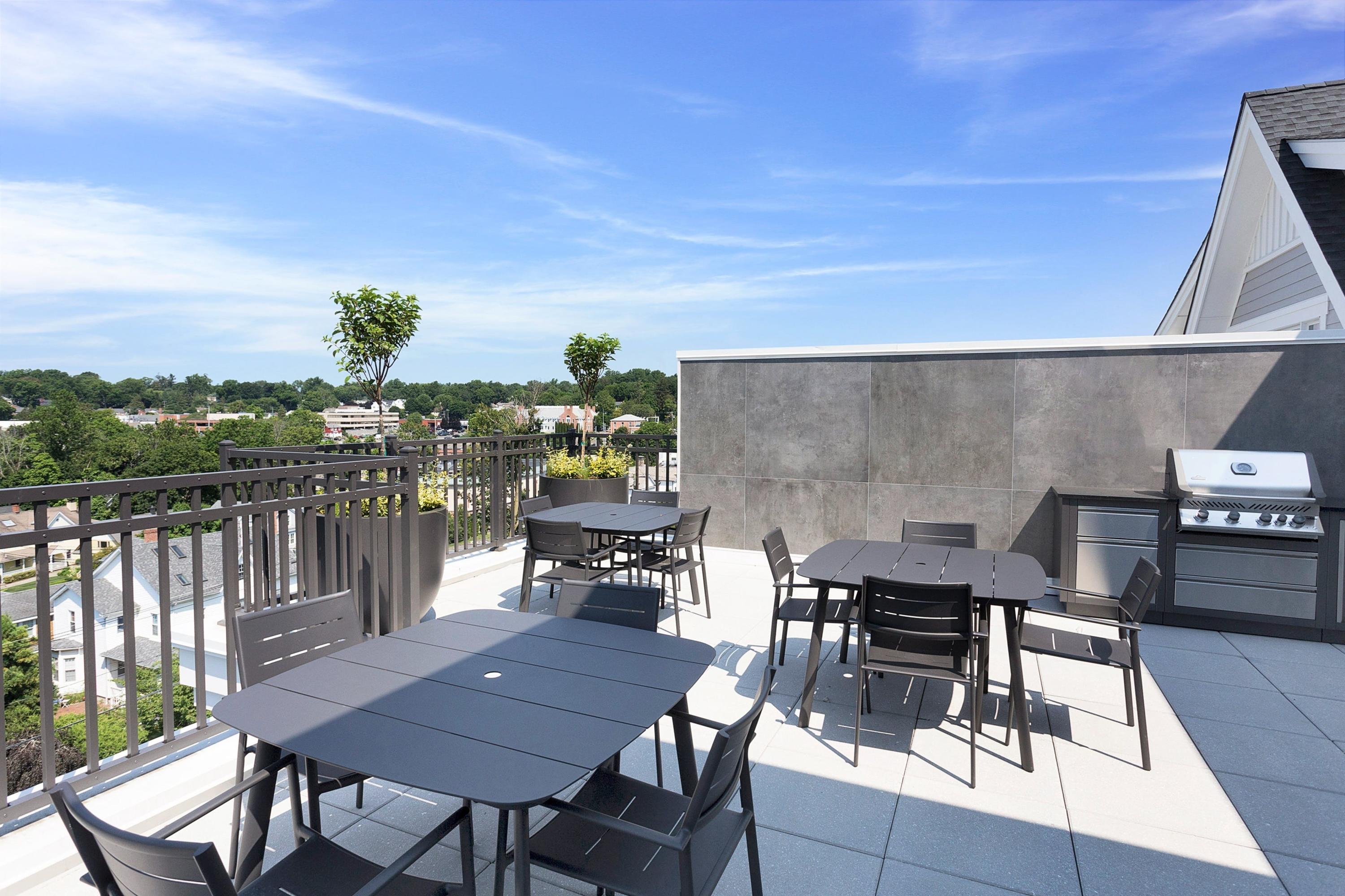 180 Park Street, Unit 204 New Canaan, CT 06840 - Photo 28 of 31 a view of a roof deck with table and chairs