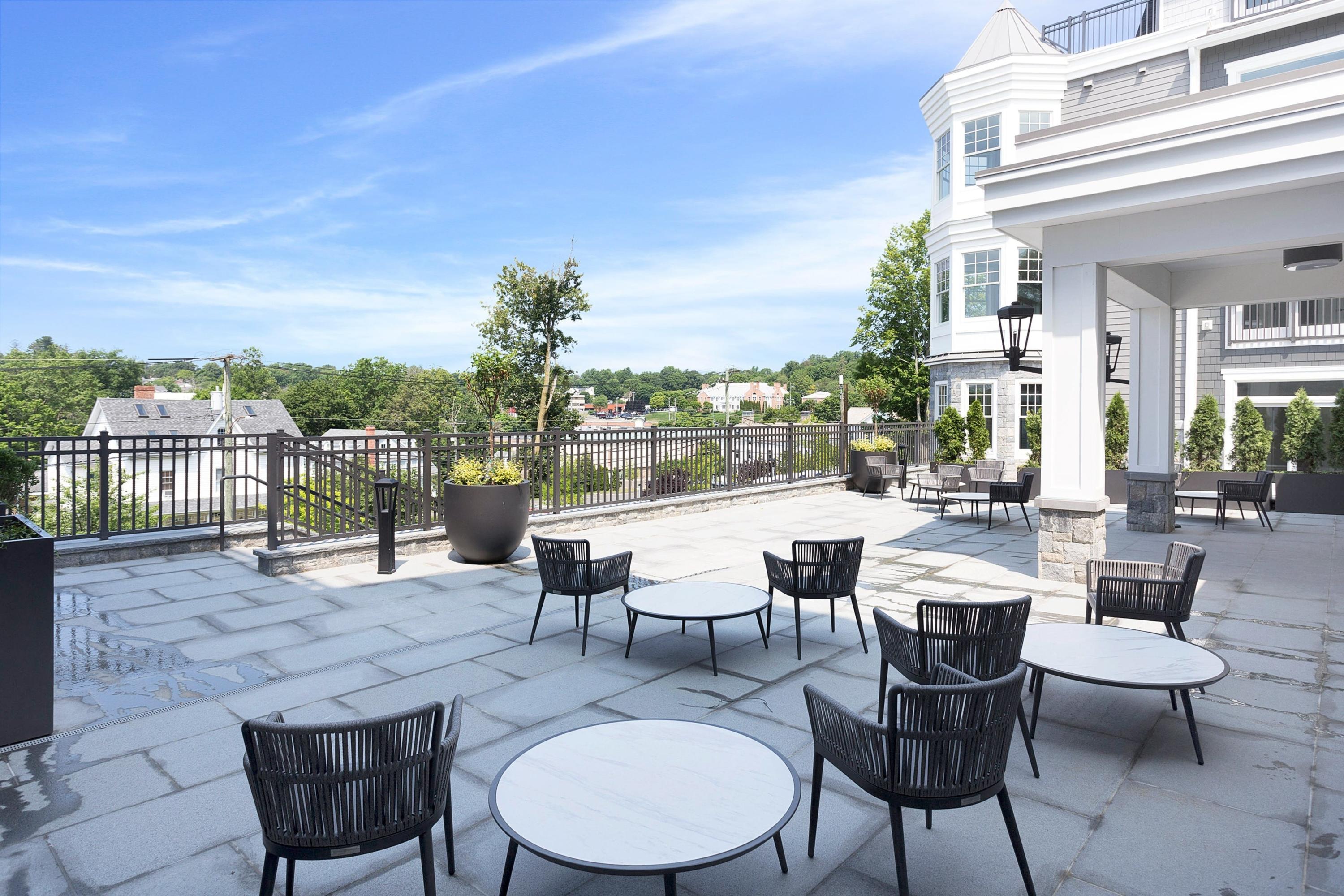 180 Park Street, Unit 204 New Canaan, CT 06840 - Photo 6 of 31 a swimming pool with outdoor seating and city view