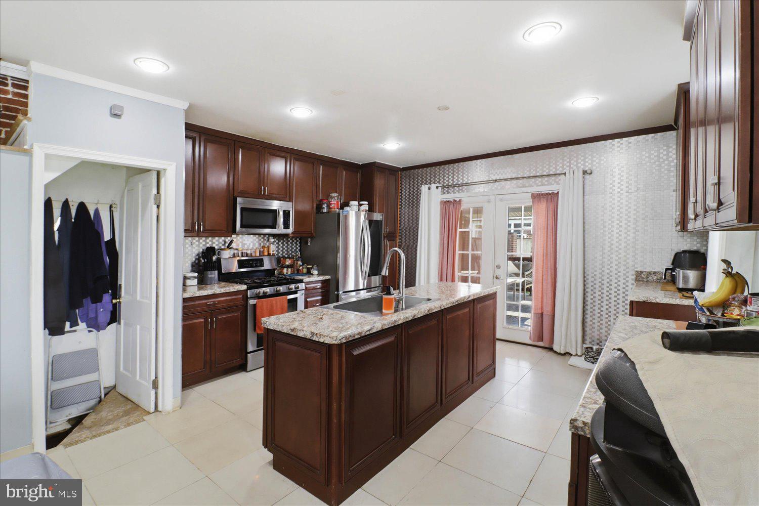 875 Manor Street Lancaster, PA 17603 - Photo 15 of 54 a kitchen with refrigerator a sink and living room view