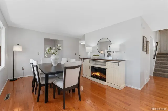a dining room with furniture and wooden floor