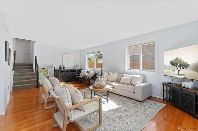 a living room with fireplace furniture and windows