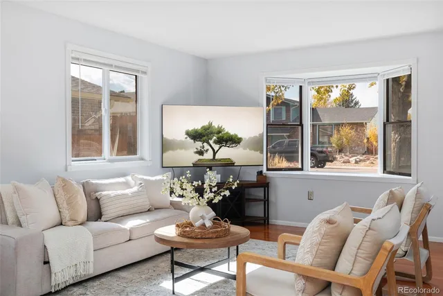 a living room with furniture and a large window