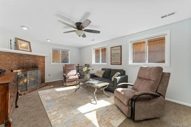 a living room with furniture and a fireplace