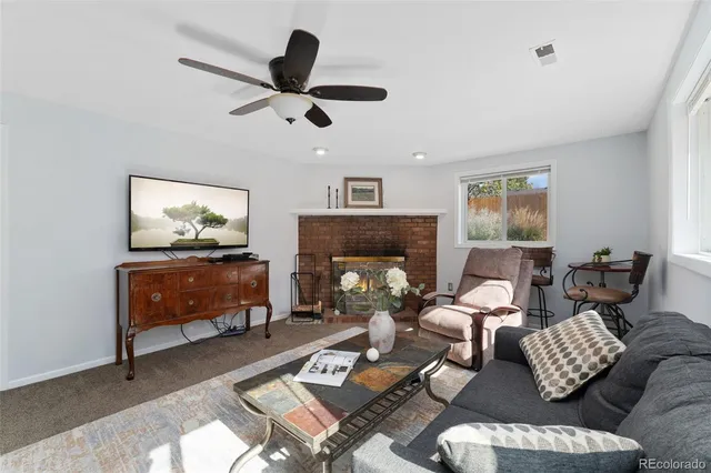 a living room with furniture and a fireplace
