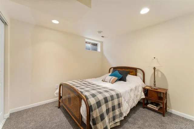 a bedroom with a bed and a lamp