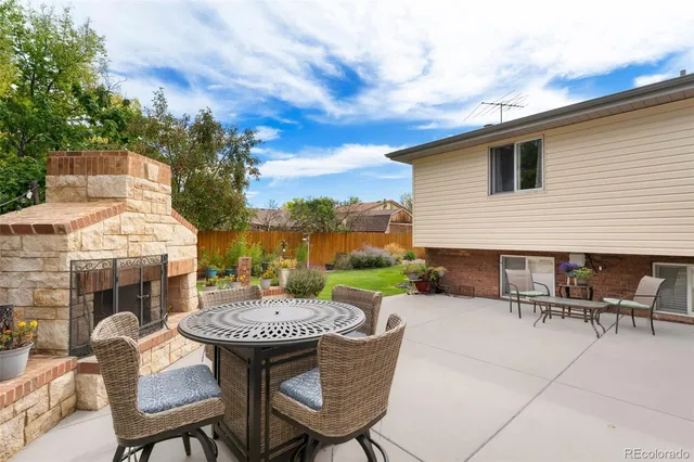 a view of a patio with a table and chairs