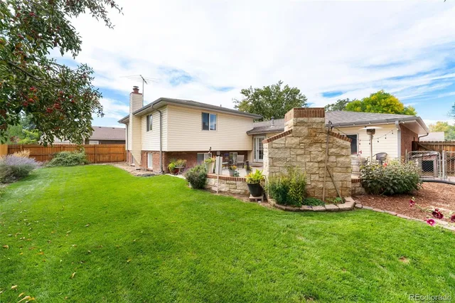 a view of a house with a yard and sitting area