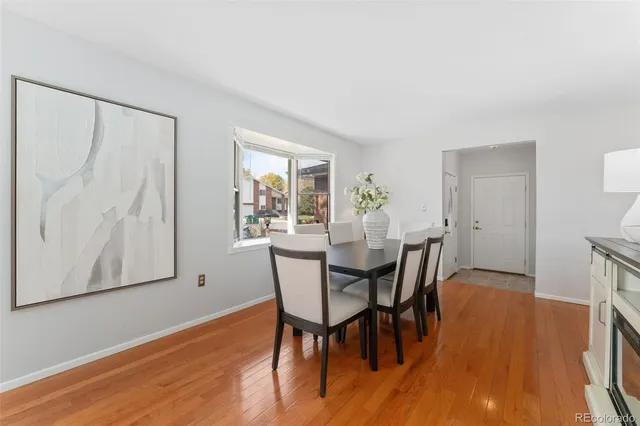 a view of a dining room with furniture and wooden floor