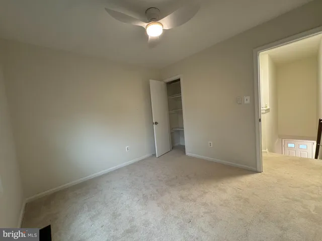 a view of an empty room and a window