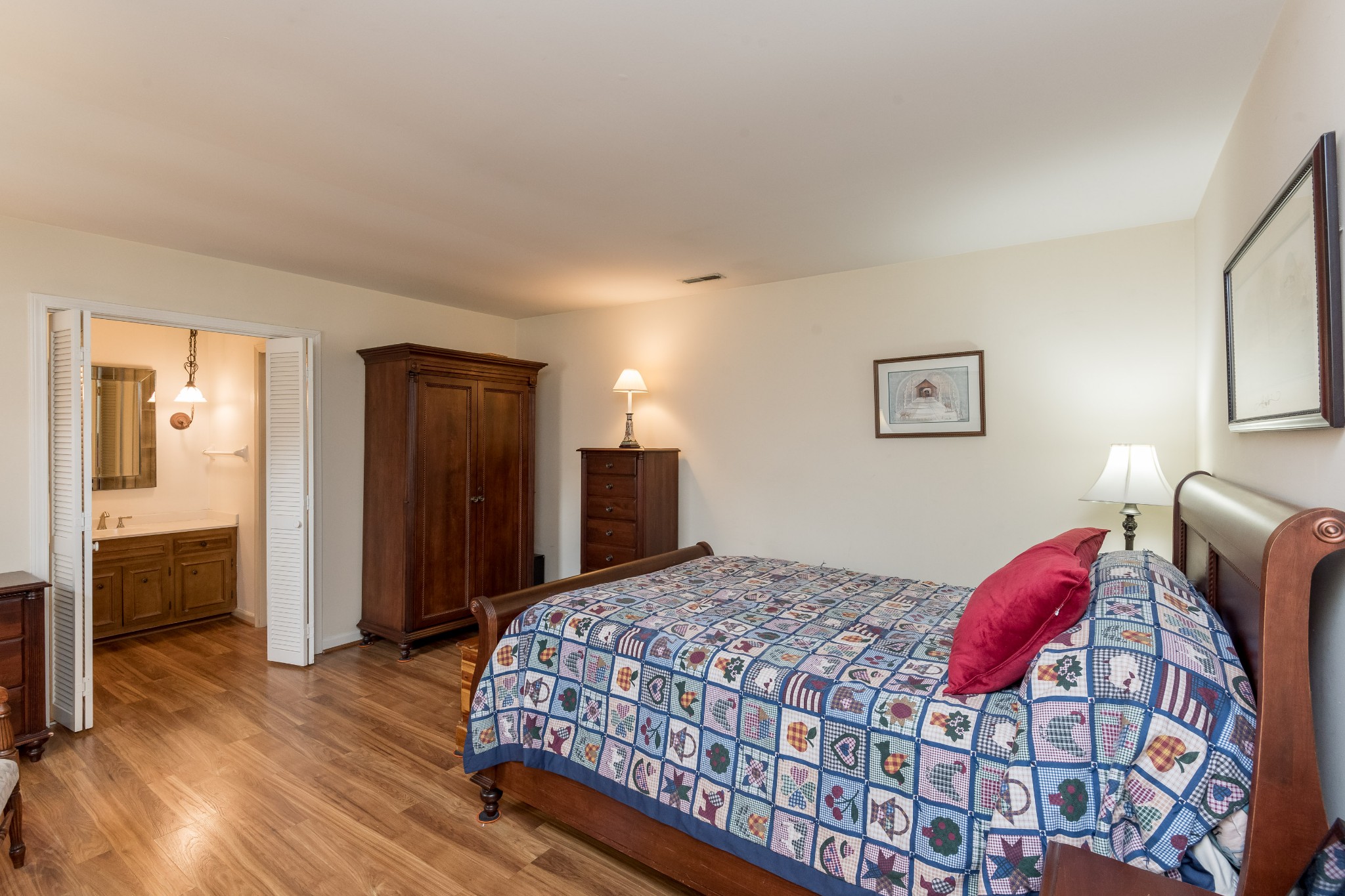 822 General George Patton Road Nashville, TN 37221 - Photo 10 of 16 a bedroom with a large bed and a chandelier