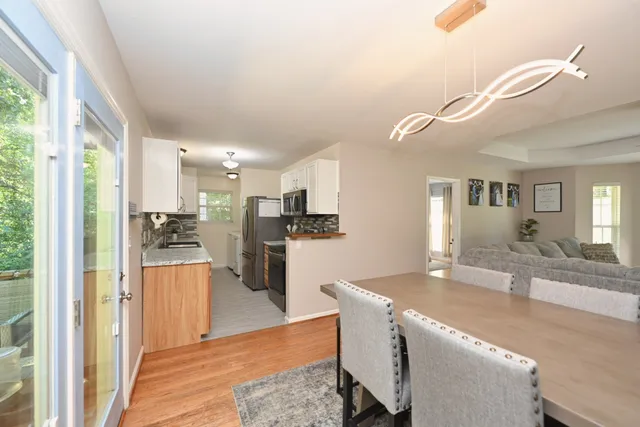 a living room with stainless steel appliances kitchen island granite countertop furniture and a kitchen view