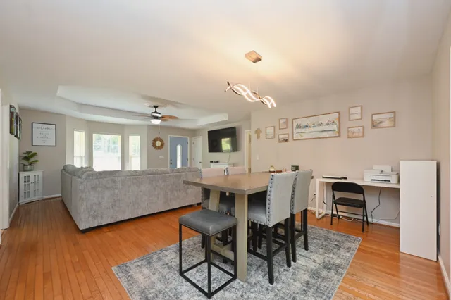 a view of a dining room with furniture and wooden floor