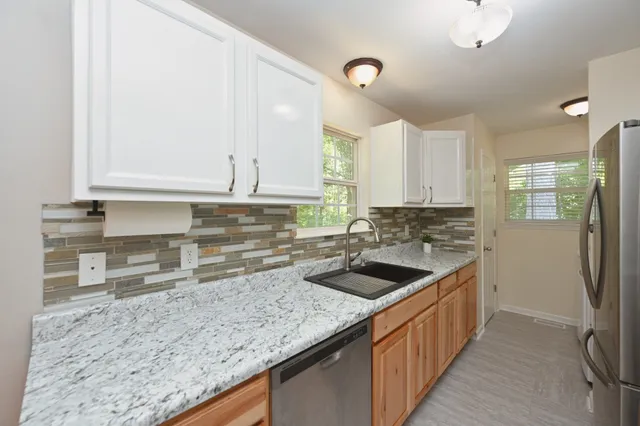 a kitchen with a sink stove and cabinets