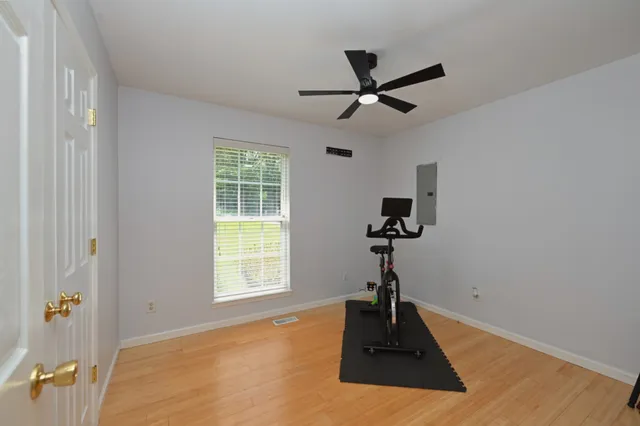 a room with a window and a ceiling fan