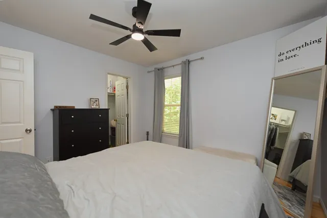 a bedroom with a bed and a chandelier