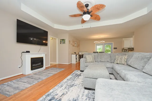 a living room with furniture a flat screen tv and a fireplace