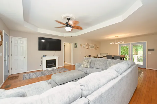 a living room with furniture a flat screen tv and a fireplace