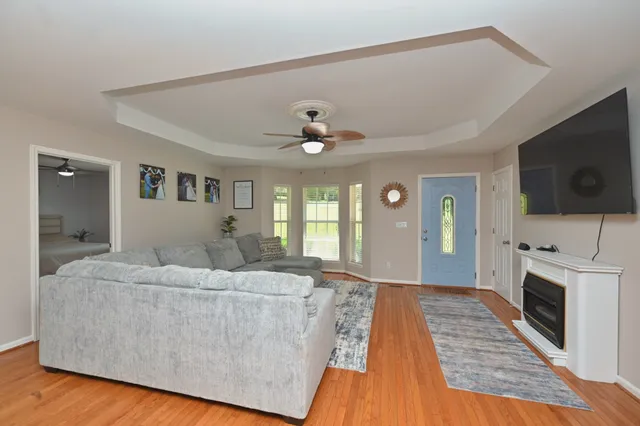 a living room with fireplace furniture and a flat screen tv