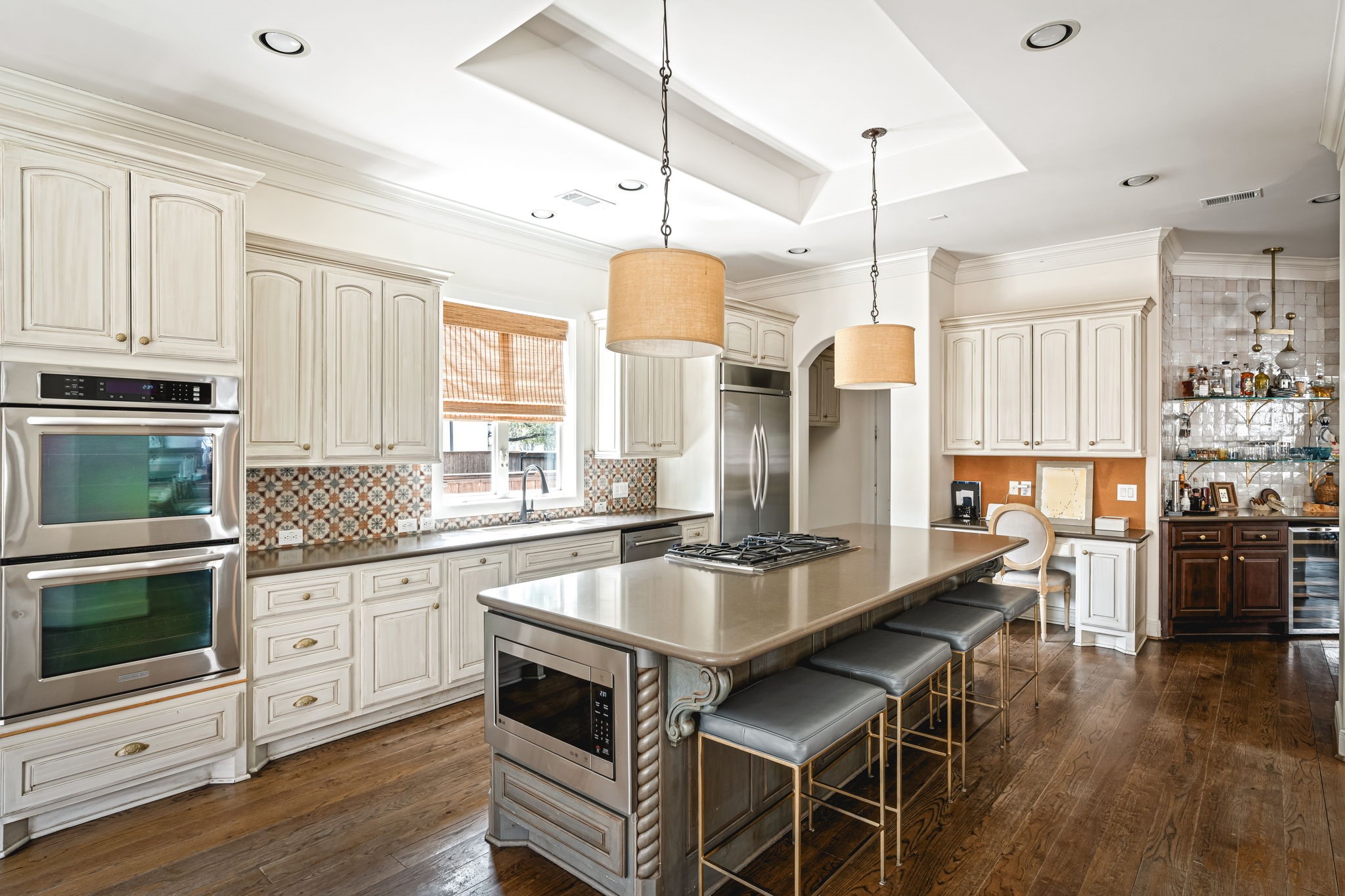 5529 Jessamine Street Houston, TX 77081 - Photo 14 of 37 a kitchen with granite countertop a stove a sink a refrigerator dining table and chairs with wooden floor